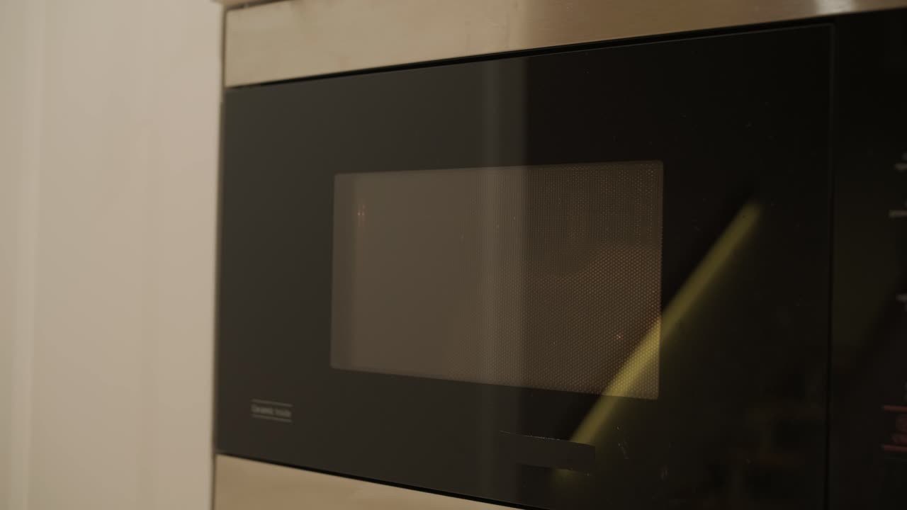 Close-up of a Microwave Oven Heating and Finishing its Cycle