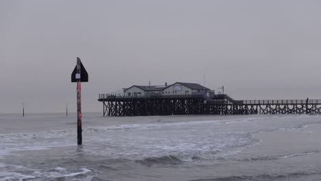 wide shot of a stilt house in sankt peter ording, northern germany