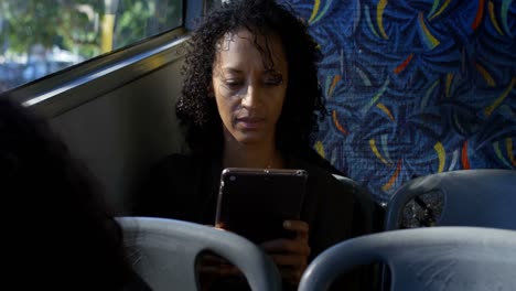 Female commuter using digital tablet in bus 4k
