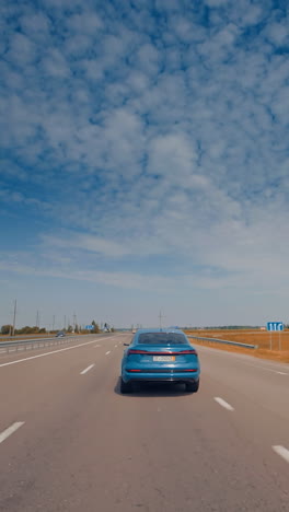 luxury comfortable ecology electric vehicle on the road. modern electric car on the road with blue sky. vertical video