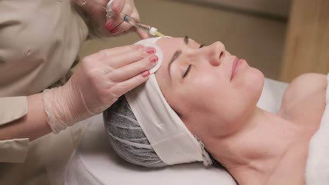 a serene patient receiving facial botulinum toxin therapy, with focus on precision and care in a clinical setting