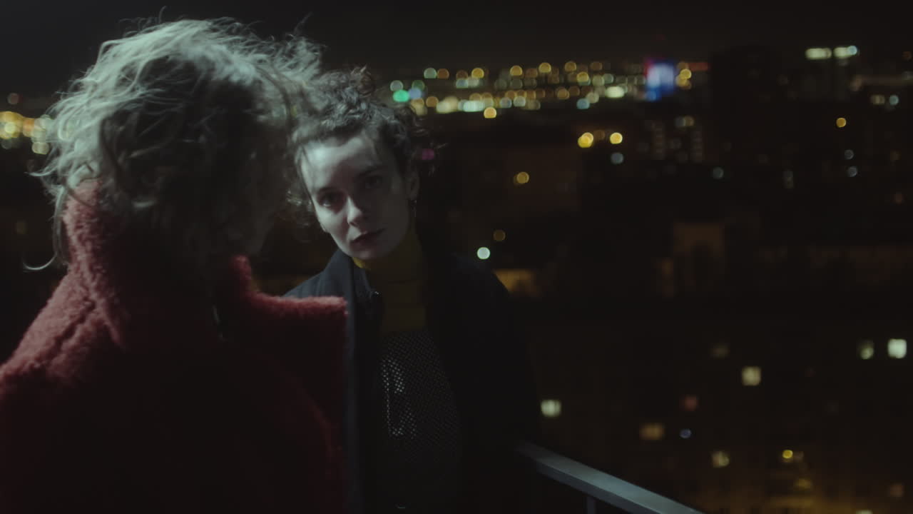 Two Women on Urban Roof at Night