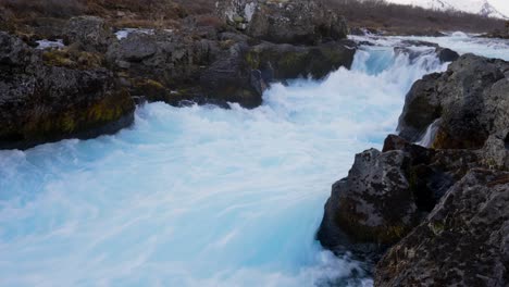 view of the narrow cascades of bruarfoss waterfall at bruara river, golden circle, southwest iceland - static shot