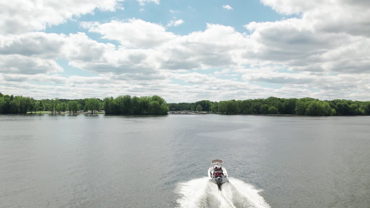 Drone view of a speed boat running in lake