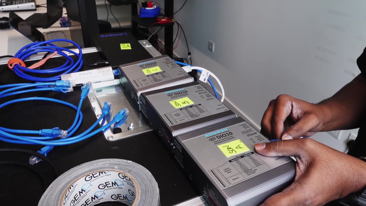 Slow orbit shot showing an engineer plugging multiple cables into a new server