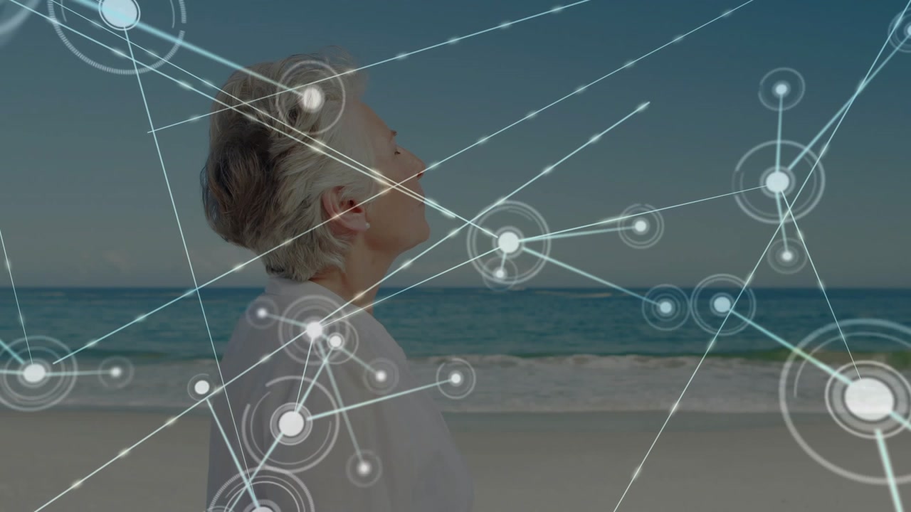 Senior woman standing shoreline initial node appearing and sparking lines around her for tech
