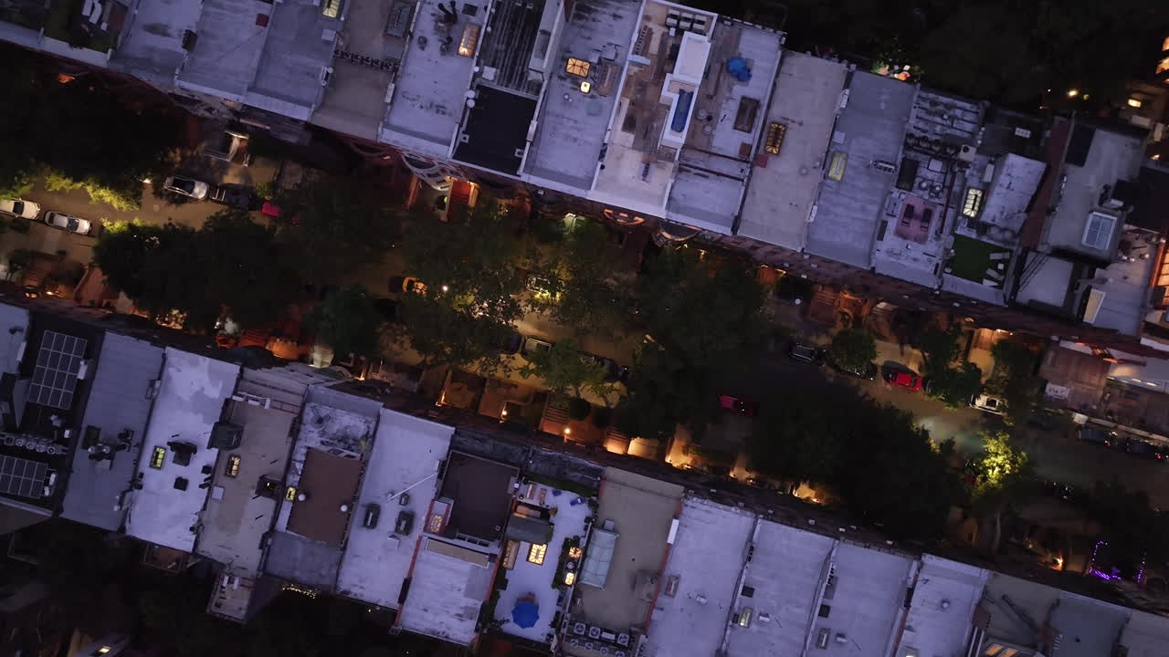 Aerial view looking down at a row of Brownstones on Manhattan's Upper West Side at night. Shot in New York City in 4k.