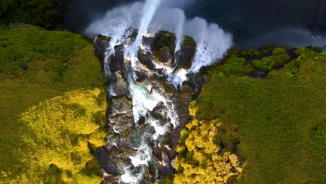 top down aerial view of scenic river mossy waterfall in iceland