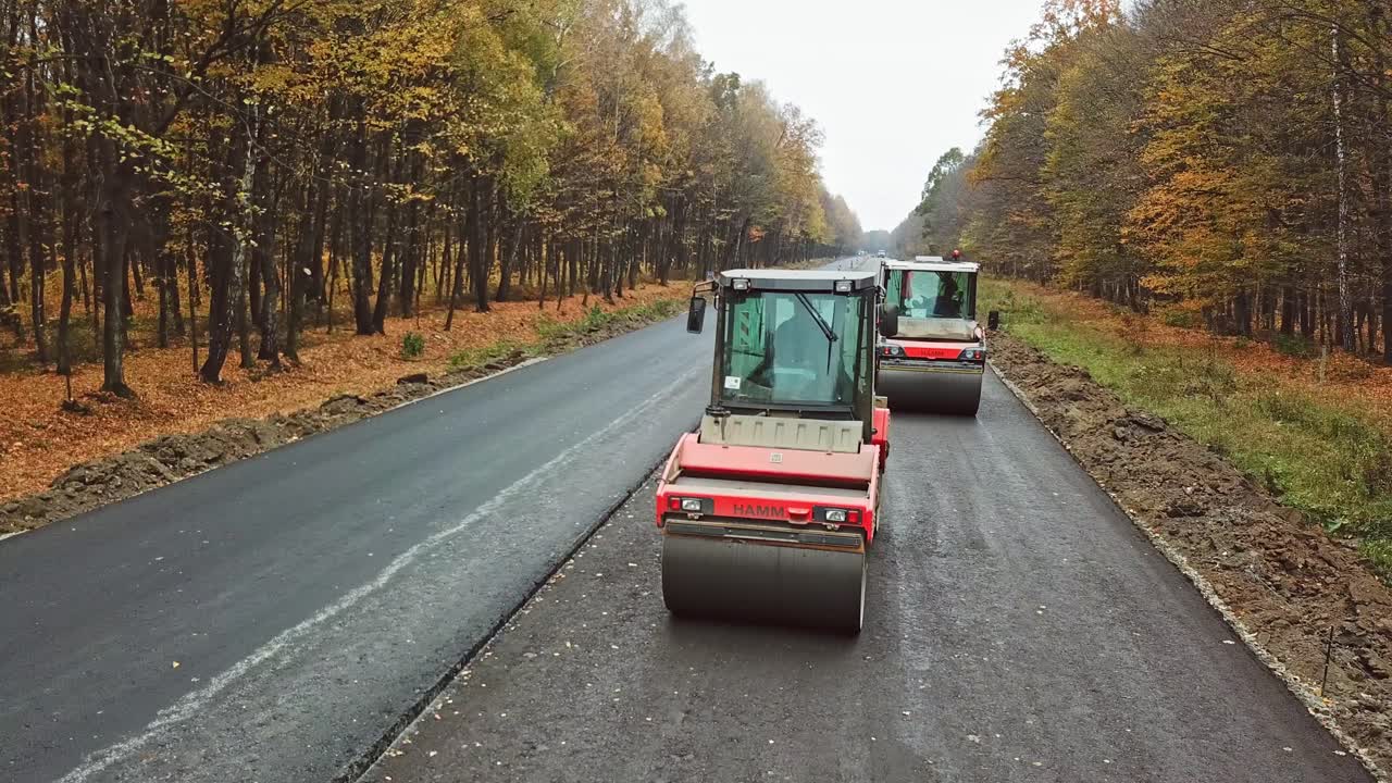 Construction and repair of highway. Aerial view on the new asphalt road under construction