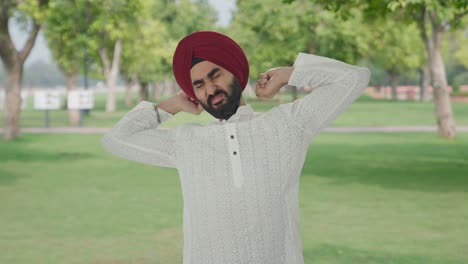 sleepy and tired sikh indian man in park