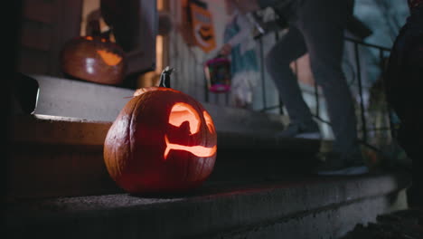 kids trick or treating out of focus behind jack o lantern