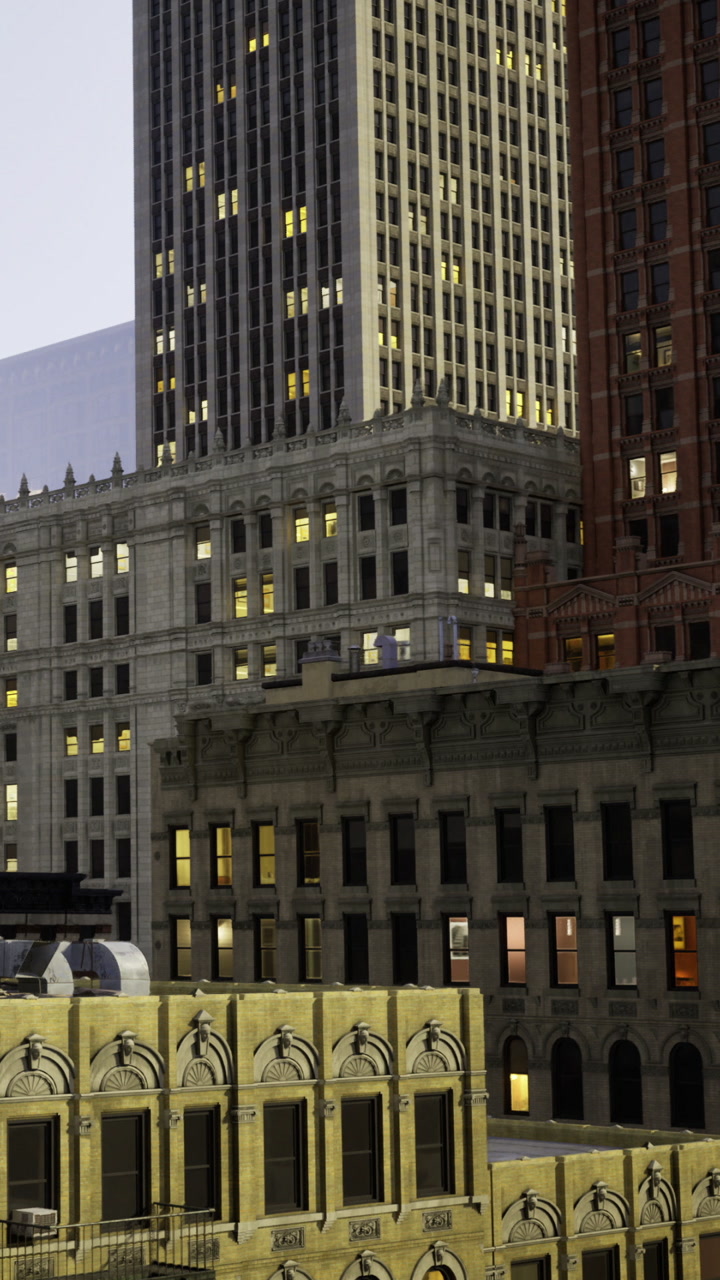 Buildings in a city with lights on at night in urban setting