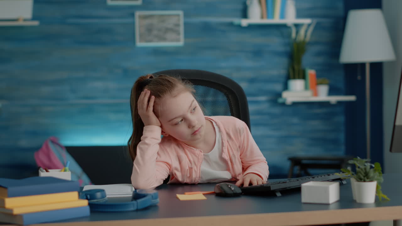 Exhausted child looking at computer for online classes