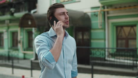 business man walking with mobile phone on the street