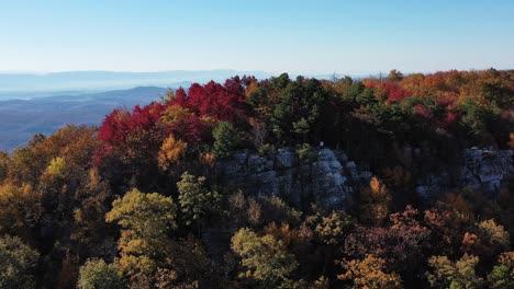 an aerial shot of a man standing on tibbet knob, part of great north mountain, the border between virginia and west virginia