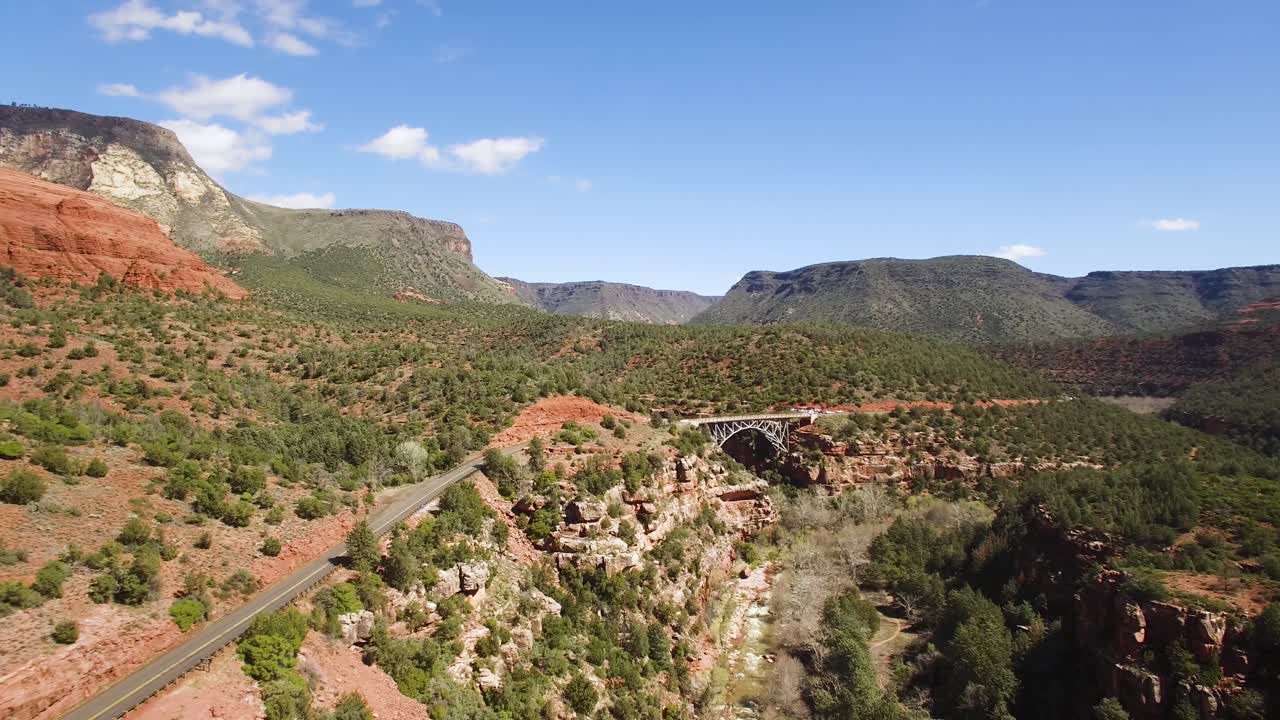 Aerial pullback from the Midgley Bridge to reveal Oak Creek flowing below, Sedona, Arizona.