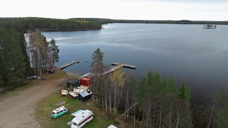 camping vans parked on the lake shore during autumn in sweden