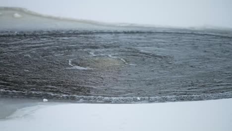 Toma-En-Cámara-Lenta-De-Agua-Hirviendo-En-Un-Agujero-De-Hielo-En-El-Sur-De-Estonia