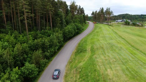 car driving towards hills golf club building in molndal near gothenburg, sweden