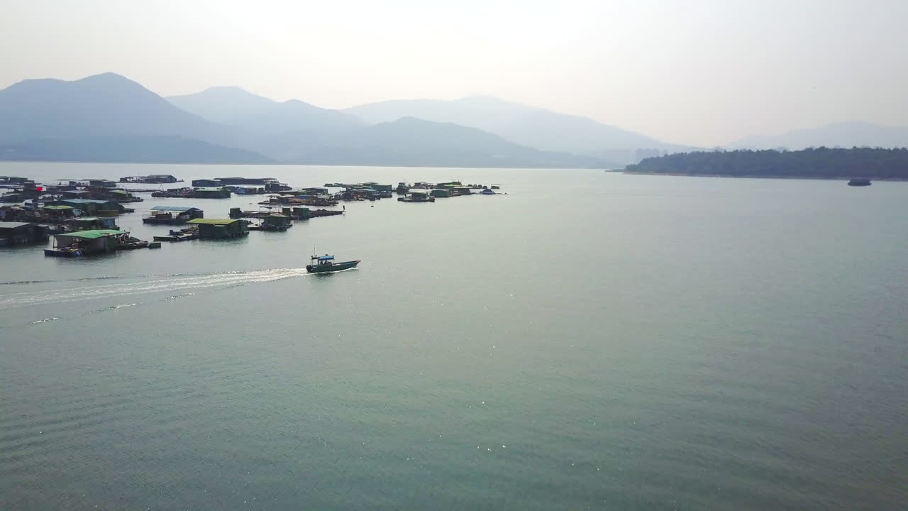 Lake with houseboats and a boat