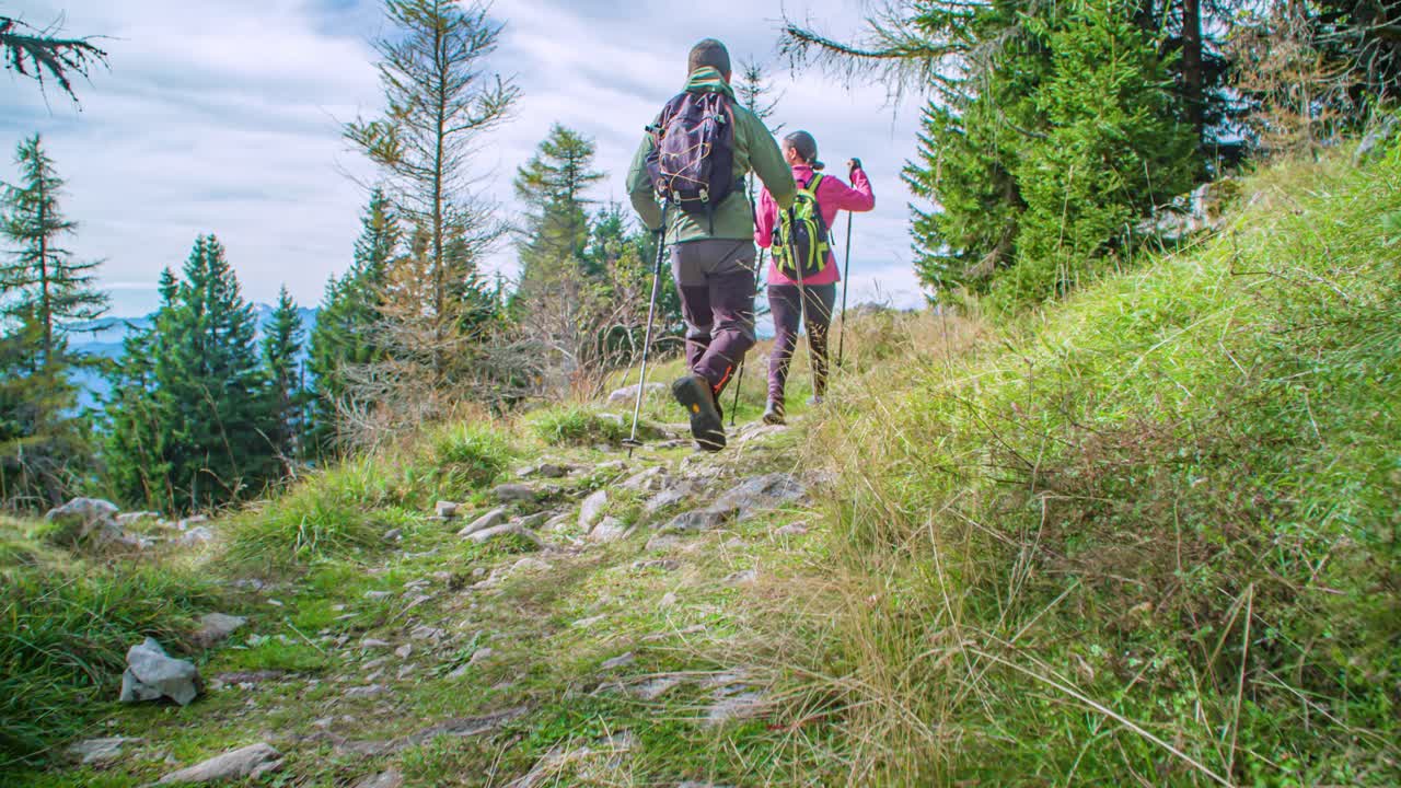 young and active hikers couple on their way to the top of the mountain. Dolly