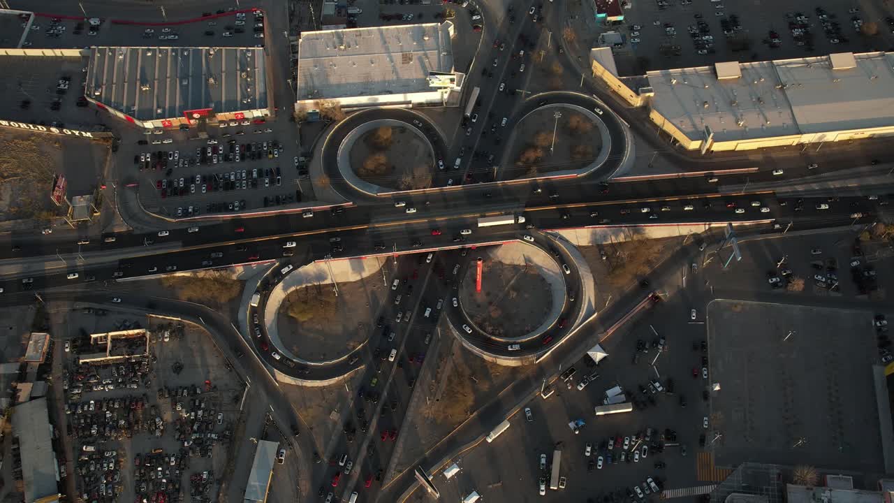 Aerial shot of a complex traffic roundabout with circular paths and cars driving through