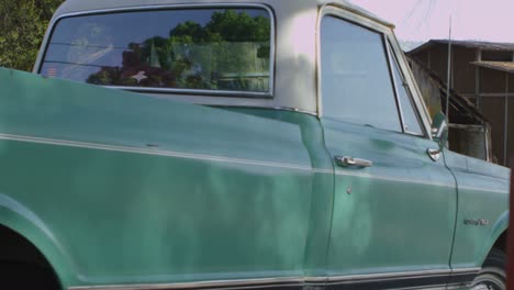 An-old-pickup-truck-pulls-up-outside-an-old-barn