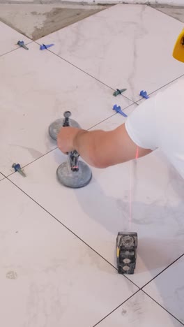 top view of laying ceramic tiles using tools and adhesive mixtures vertical video