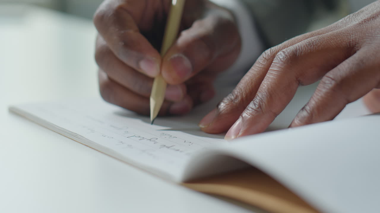 Hands of Businessman Taking Notes with Pencil