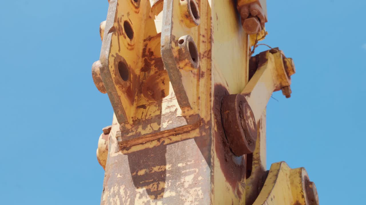 Detail clips of a construction excavator at the beach. Clip 5