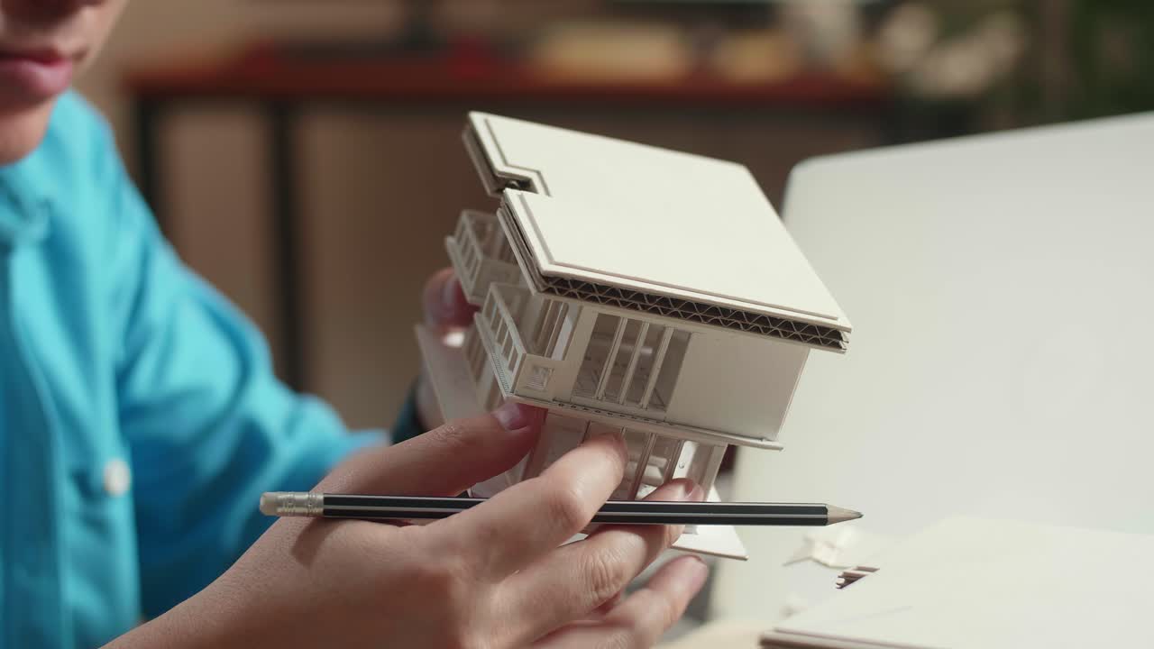 Close Up Of Hand'S Man Engineer Holding Paper Model Of House At The Office