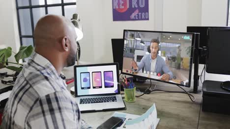 African-american-businessman-on-video-call-with-caucasian-male-colleague-on-screen