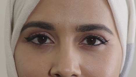 young muslim woman eyes looking at camera blinking wearing hijab feminine beauty close up