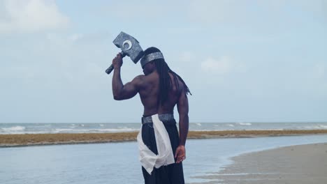 the tropical beach provides the ideal setting for a muscular, dark-skinned man as nekharis in cosplay