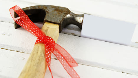 decorated hammer on wooden plank 4k