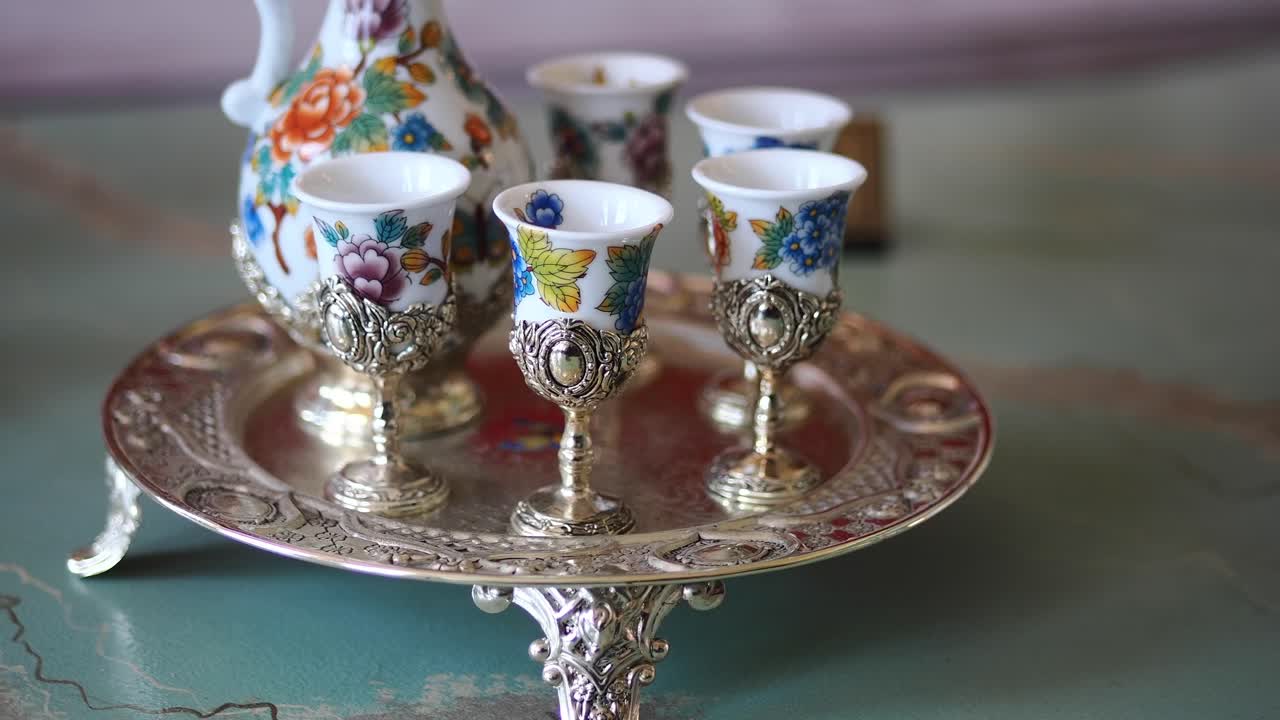 Decorative Floral Porcelain Cups on an Ornate Silver Tray