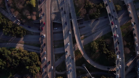 birdseye aerial view of traffic on american highway junction and overpass, top down drone shot