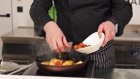 chef preparing a chicken and vegetable dish