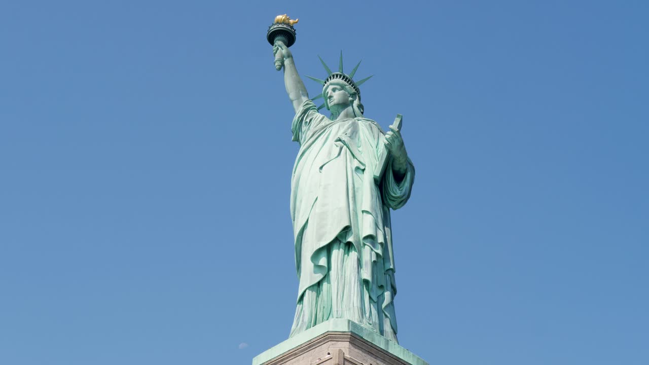 Slow motion landscape of Statue of Liberty monument landmark holding torch iconic New York City tourism sightseeing USA America travel Battery Park Manhattan
