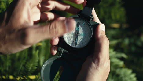 opening a compass in the mountains