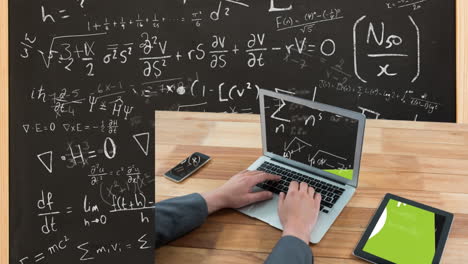 animation of mathematical equations over caucasian man using laptop and black board