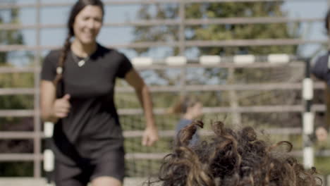 front view of cheerful female football players rejoicing victory on the field