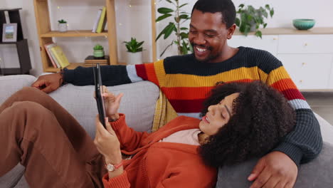 Black-couple,-tablet-and-relax-on-couch-in-home