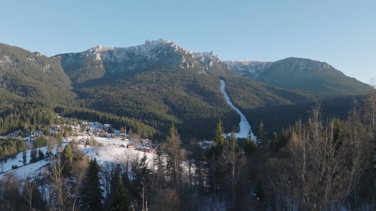 Aerial View of a Snow Covered Mountain Village in Winter