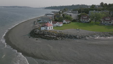 Slow-aerial-rotation-around-the-Alki-Point-lighthouse-in-Seattle,-Washington