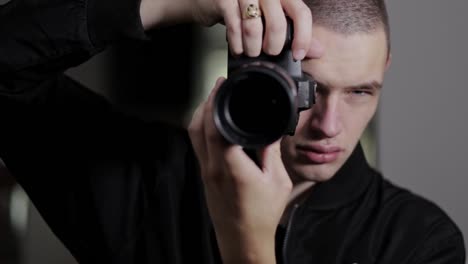 photographer rotating the zoom ring of a dslr camera - medium shot