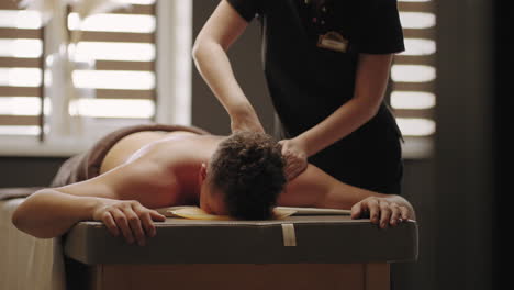 el osteópata está masajeando la espalda del paciente masculino en la clínica médica de curación y prevención de enfermedades vertebrales