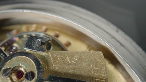 close-up of a watch movement with "fast" adjustment