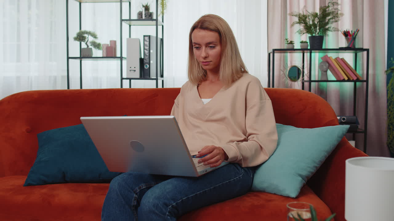 Overjoyed young woman working on laptop celebrate success win money in lottery get online good news