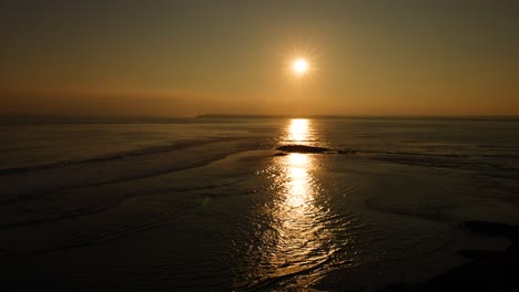 sunset reflecting on calm coastal waters